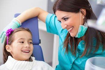 Dentist cleaning teeth in Dentist service - KY, USA Dentist cleaning teeth in Dentist service - KY, USA