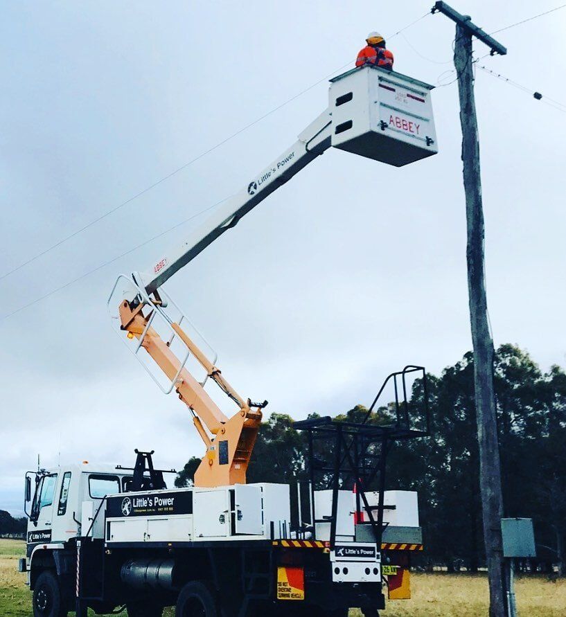 Electrician Inspecting Power Line — Electrical Services in Orange, NSW Electrician Inspecting Power Line — Electrical Services in Orange, NSW