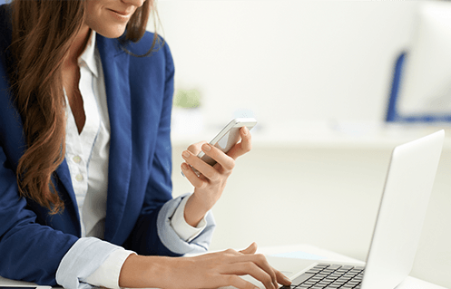 woman on phone and laptop