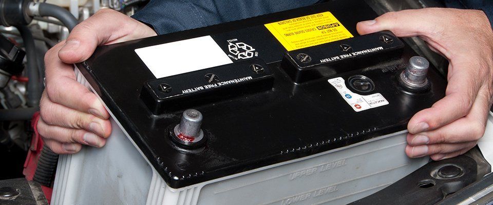 Hands holding a new battery