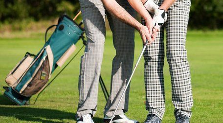 giving advice on holding golf club