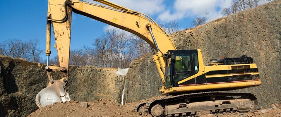 large yellow excavator on site