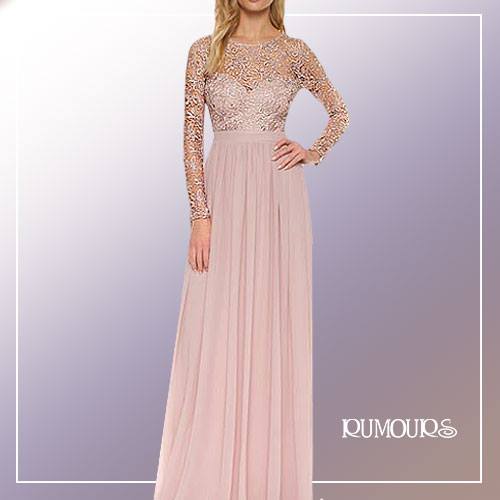 Woman in a blush pink dress with lace bodice, long sleeves, and pleated skirt.