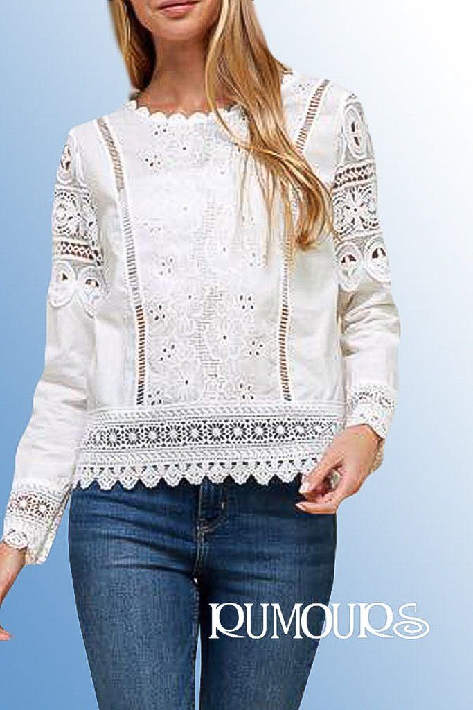 White lace blouse on woman with blue jeans.