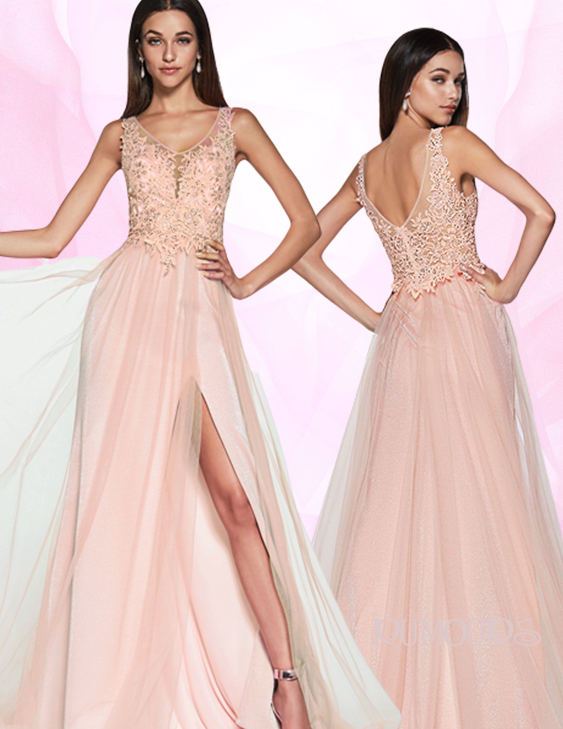 Woman in a pink formal gown with a high slit, posing with hands on hips, a sheer background.