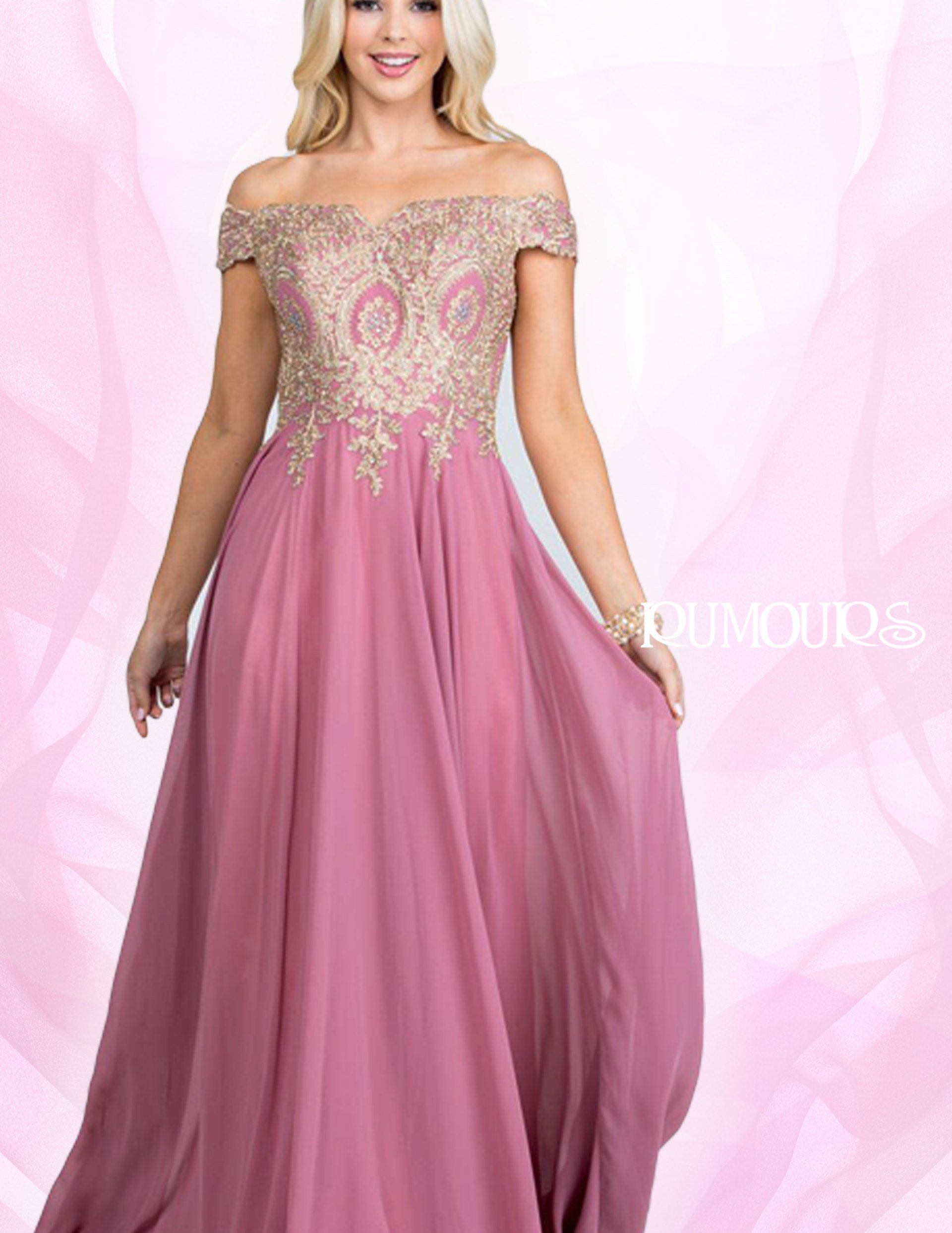 Woman in a mauve off-the-shoulder gown with gold embroidery, posing in front of a pink backdrop.