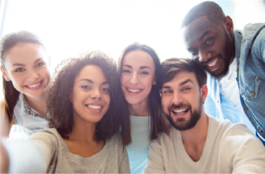 Group of five smiling people taking a selfie, ready to be served.