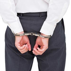 Defense — Close Up on Young Businessman Wearing Handcuffs in York, PA Defense — Close Up on Young Businessman Wearing Handcuffs in York, PA