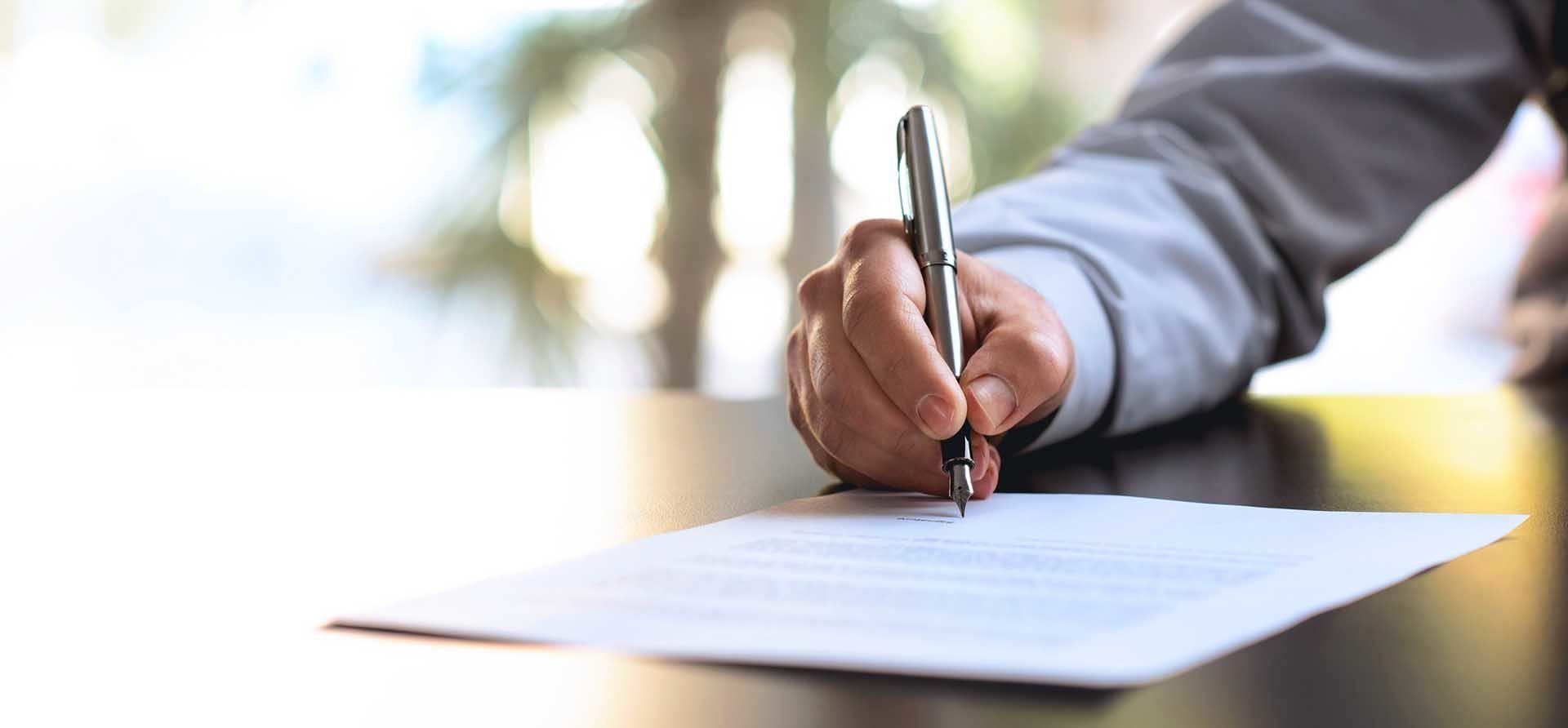 Trustworthy Attorney — Man Signing An Official Document in Gillette, WY