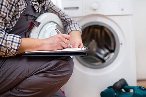 Repairman Entering malfunction of a Washing Machine - Appliance Service and Repair in Worth, IL Repairman Entering malfunction of a Washing Machine - Appliance Service and Repair in Worth, IL
