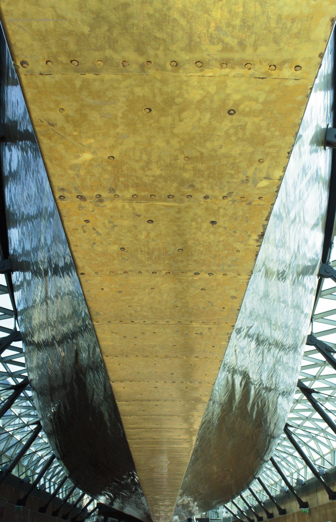 Looking up at the copper coated prow of the Cutty Sark clipper sailing ship in its dry doc at Greenwich London.