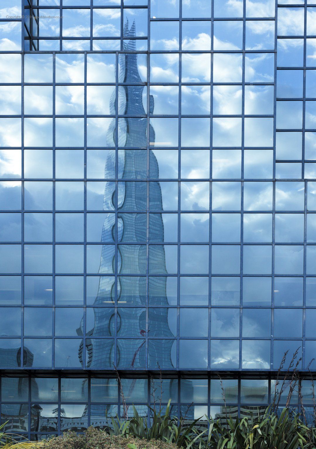 The Shard building on the south bank Lndon reflected in north bank office block windows.