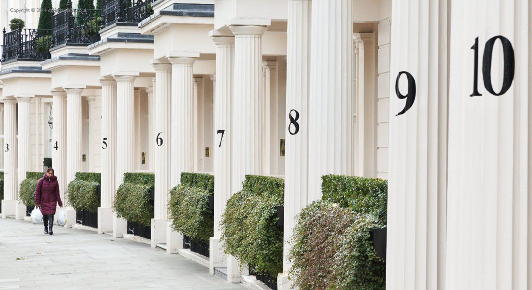 Belgravia London with numbered houses and a passer by.