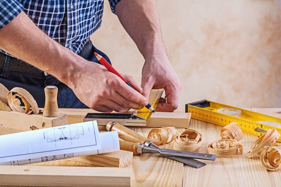 Falegname durante la progettazione di un mobile in legno