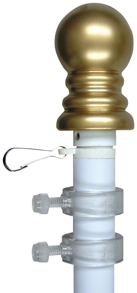 A white pole with a gold ball on top of it.
