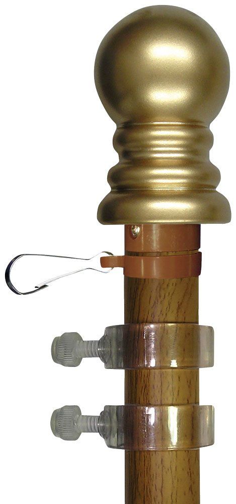 A wooden pole with a gold ball on top of it.
