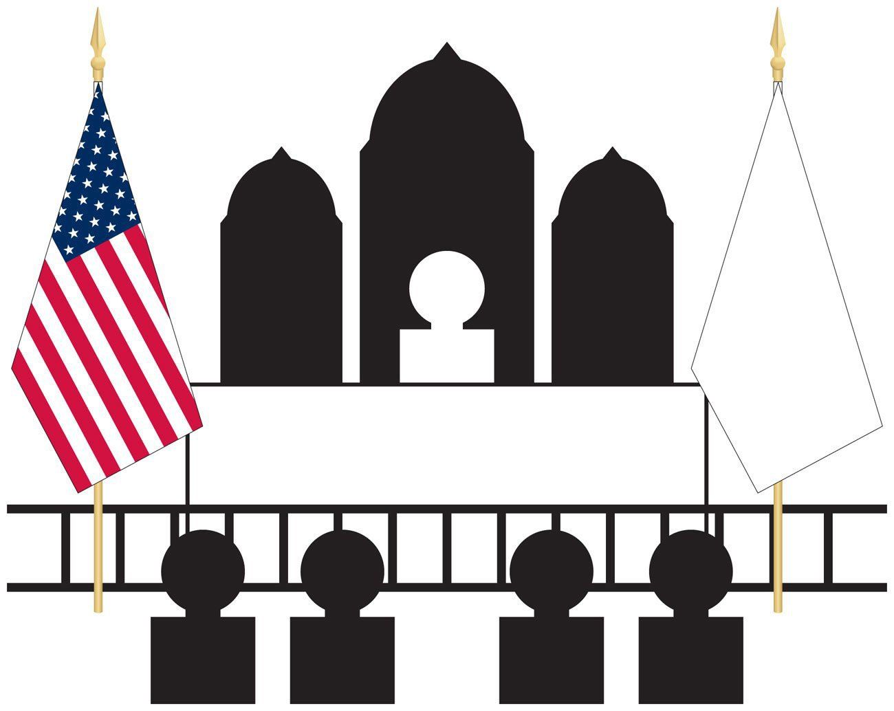 A group of people sitting in front of a building with flags hanging from poles.
