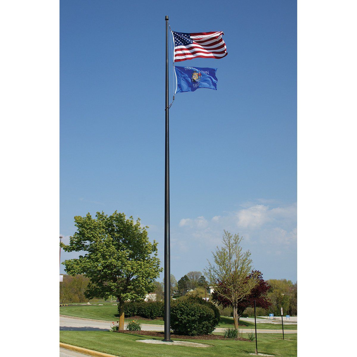 A flag pole with three flags on it