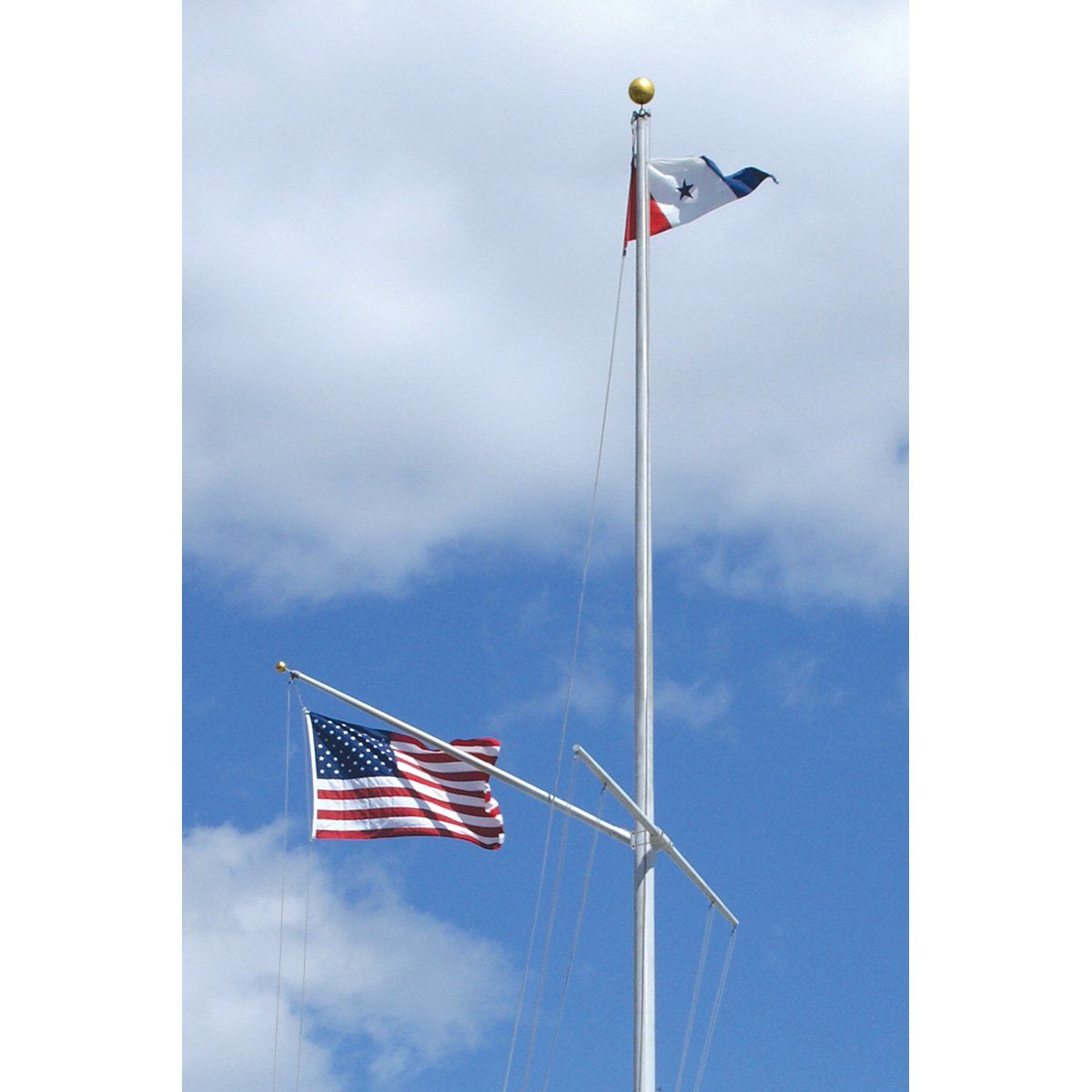Two flags on a pole with a blue sky in the background