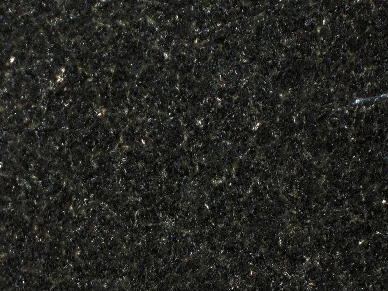 A close up of a black granite counter top