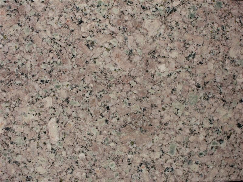 A close up of a pink granite counter top.