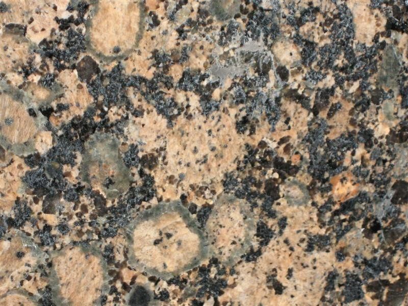 A close up of a brown and black granite counter top