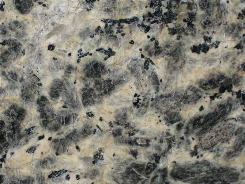 A close up of a granite counter top with black and white spots.