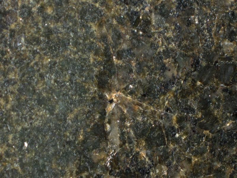A close up of a black granite counter top.