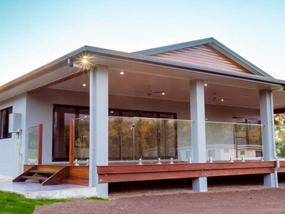 A house with a large porch and a glass railing