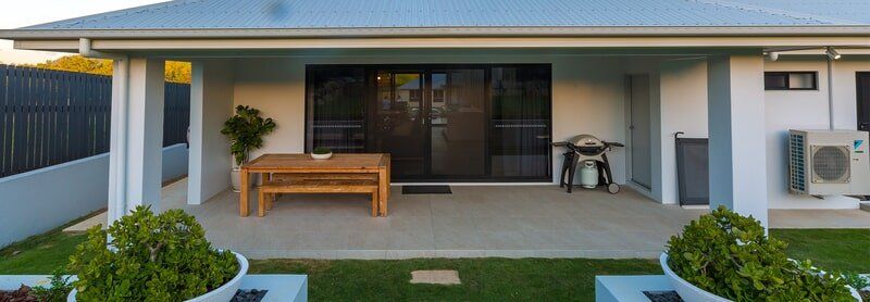 A house with a patio and a table and chairs on it.