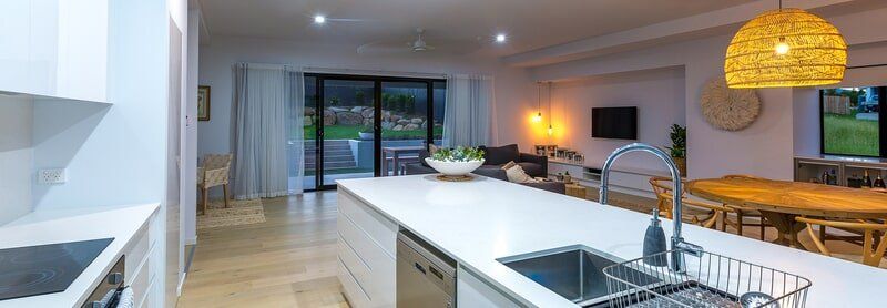 A kitchen with a sink , stove , dishwasher and stainless steel appliances.