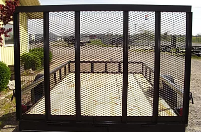 Black metal mesh trailer gate on a rooftop overlooking a city