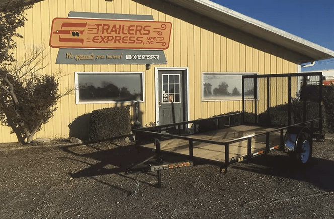 Trailer Express building with a metal trailer parked outside on a sunny day