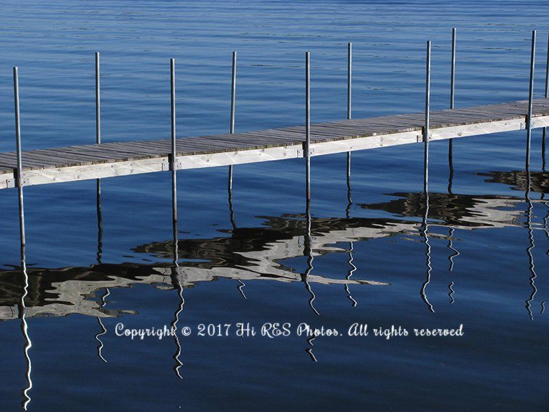 A dock in the middle of a body of water with copyright written on the bottom