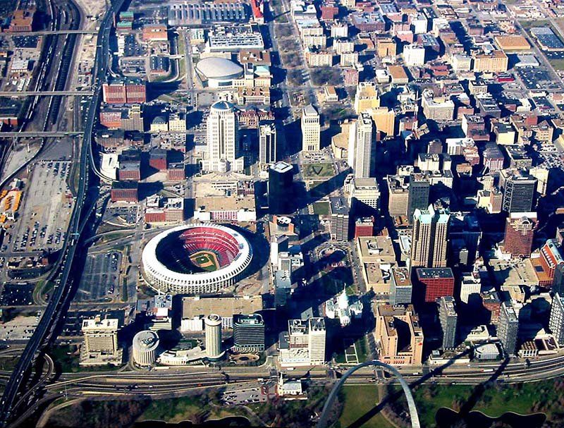 An aerial view of a city with a stadium in the middle