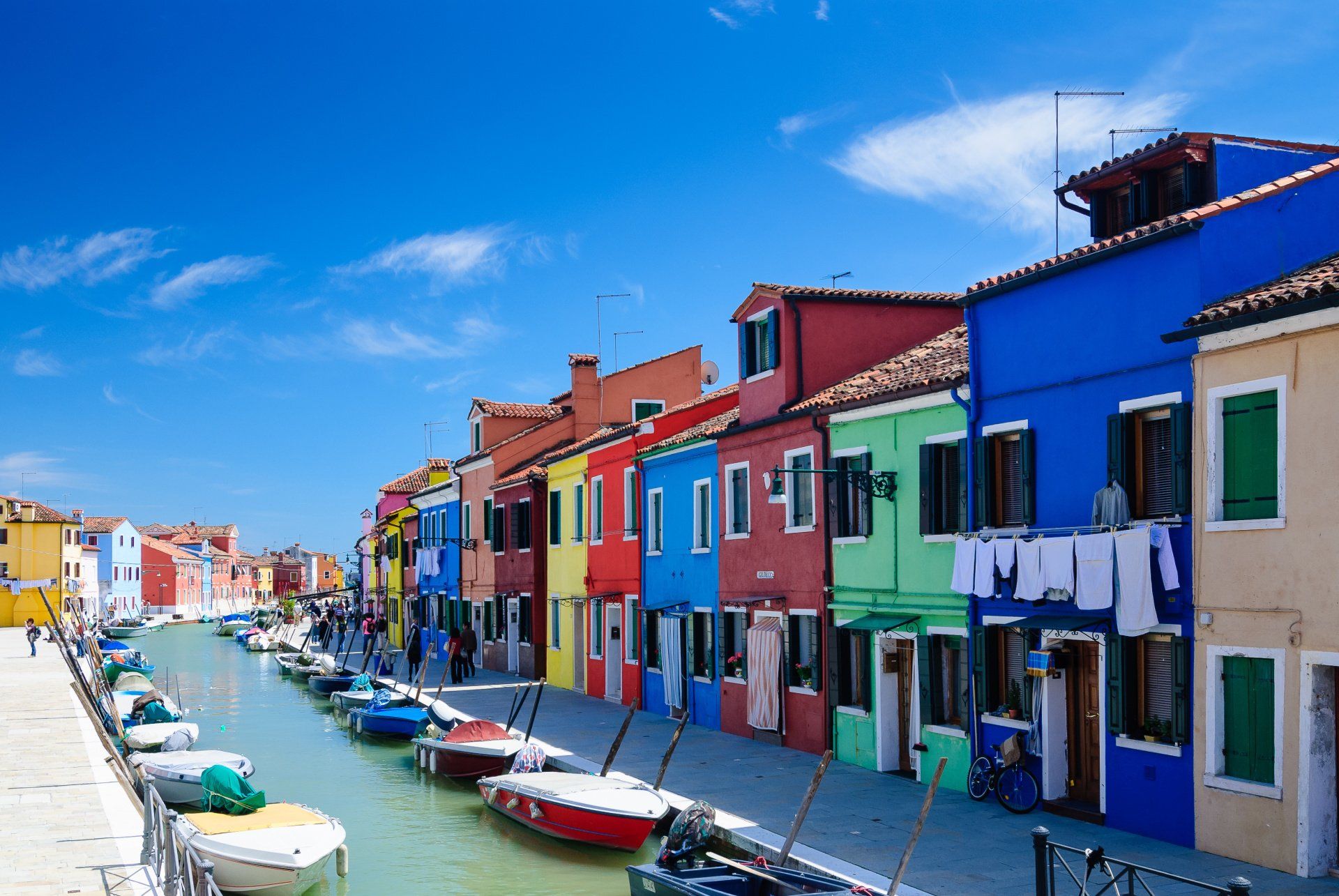 A row of colorful buildings next to a canal
