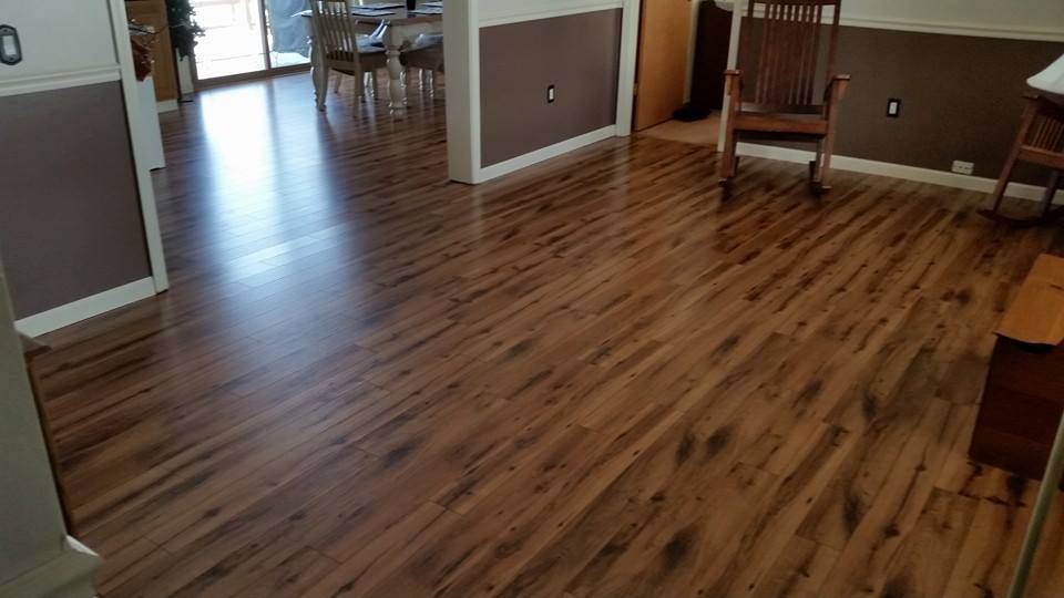 A living room with hardwood floors and a rocking chair.