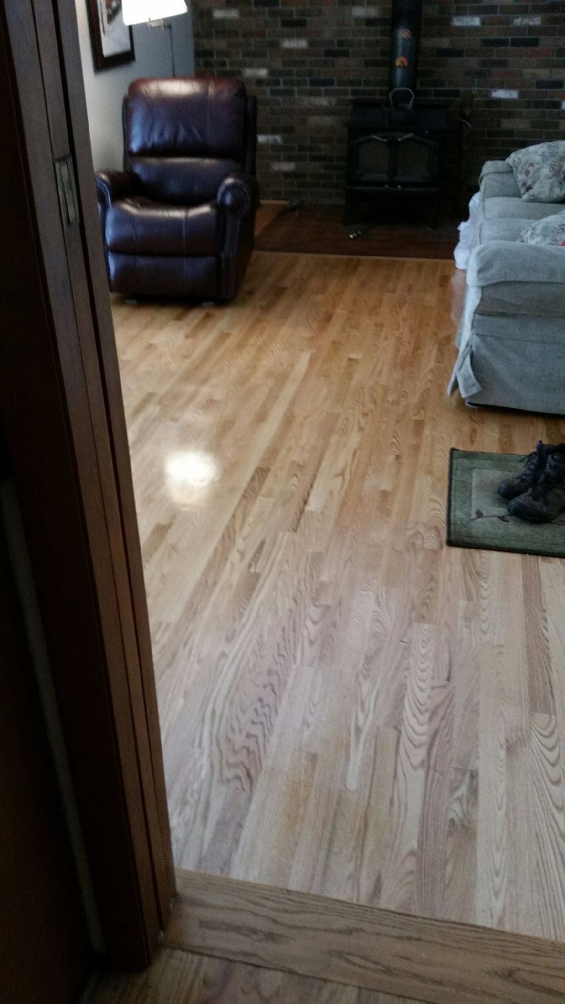 A living room with hardwood floors and a leather recliner.