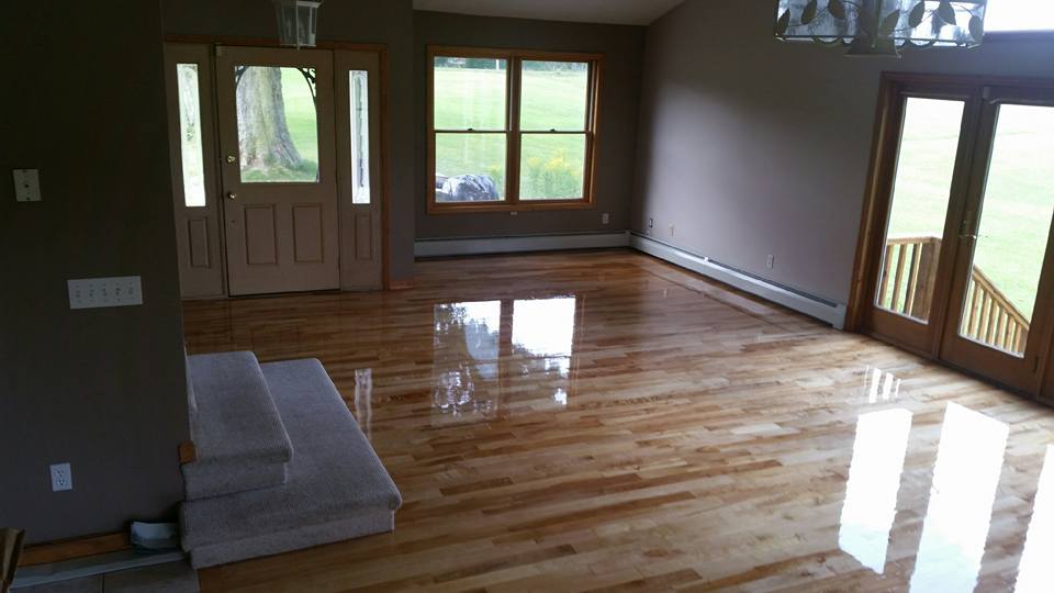 A living room with hardwood floors and sliding glass doors