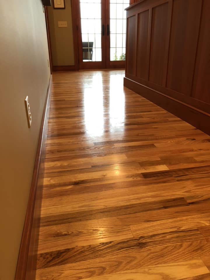 A hallway with hardwood floors and sliding glass doors.