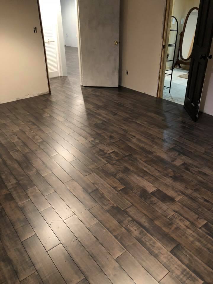 A room with a wooden floor and a mirror.