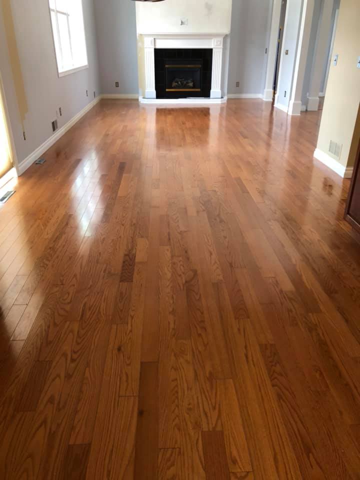 A living room with hardwood floors and a fireplace.