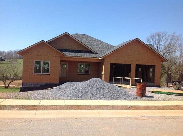 Big house with mountain of sand and gravel — custom siding in Elizabethton, TN
