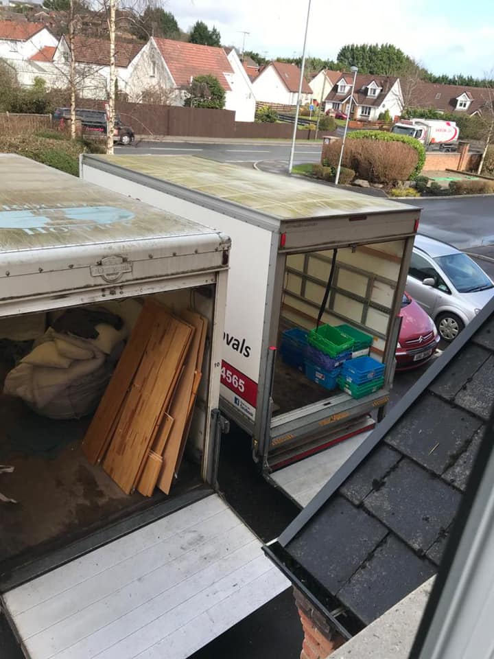 Two removals vans parked next to each other with items in the back