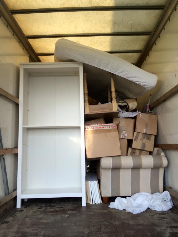 View into the back of a removals van, packed with furniture and boxes