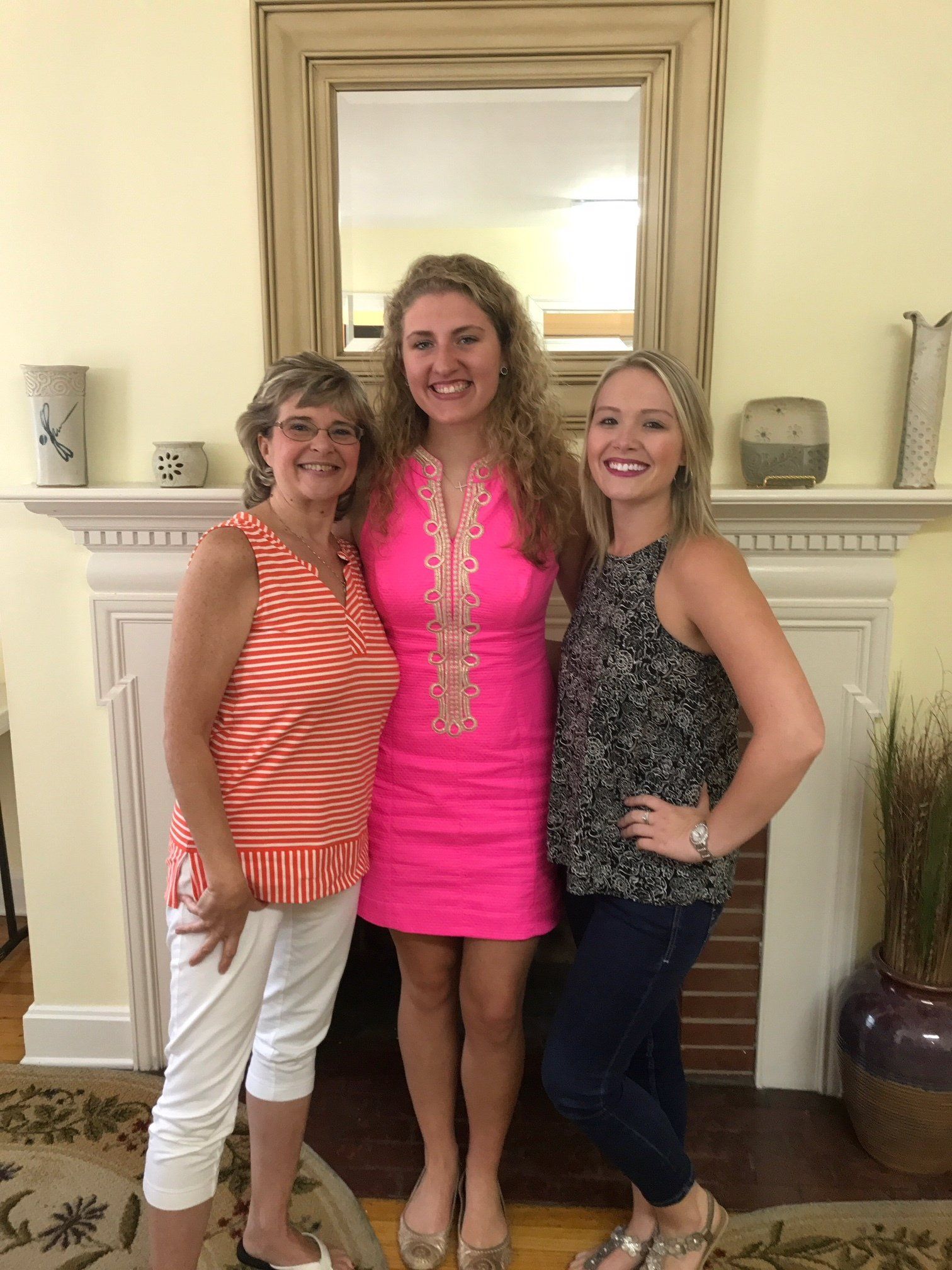 The V.S. Rich Realty Team pose for a photo in front of a fire place