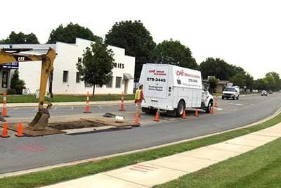 Excavator and Container Van on Road — Drain Cleaning in Columbus, OH Excavator and Container Van on Road — Drain Cleaning in Columbus, OH