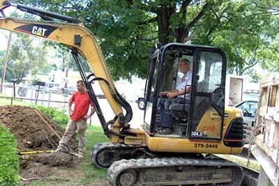 Man Operating Excavator — Drain Cleaning in Columbus, OH Man Operating Excavator — Drain Cleaning in Columbus, OH