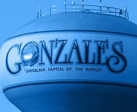 A water tower with the name gonzales on it