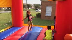 Kid playing in bounce house — Preschool & Daycare in Virginia Beach, VA Kid playing in bounce house — Preschool & Daycare in Virginia Beach, VA